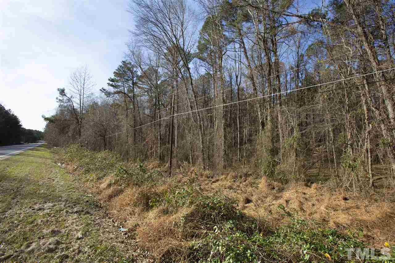 5112 Durham Road Wake Forest, NC 27587 - Photo 16 of 18 a view of a yard with trees in the background