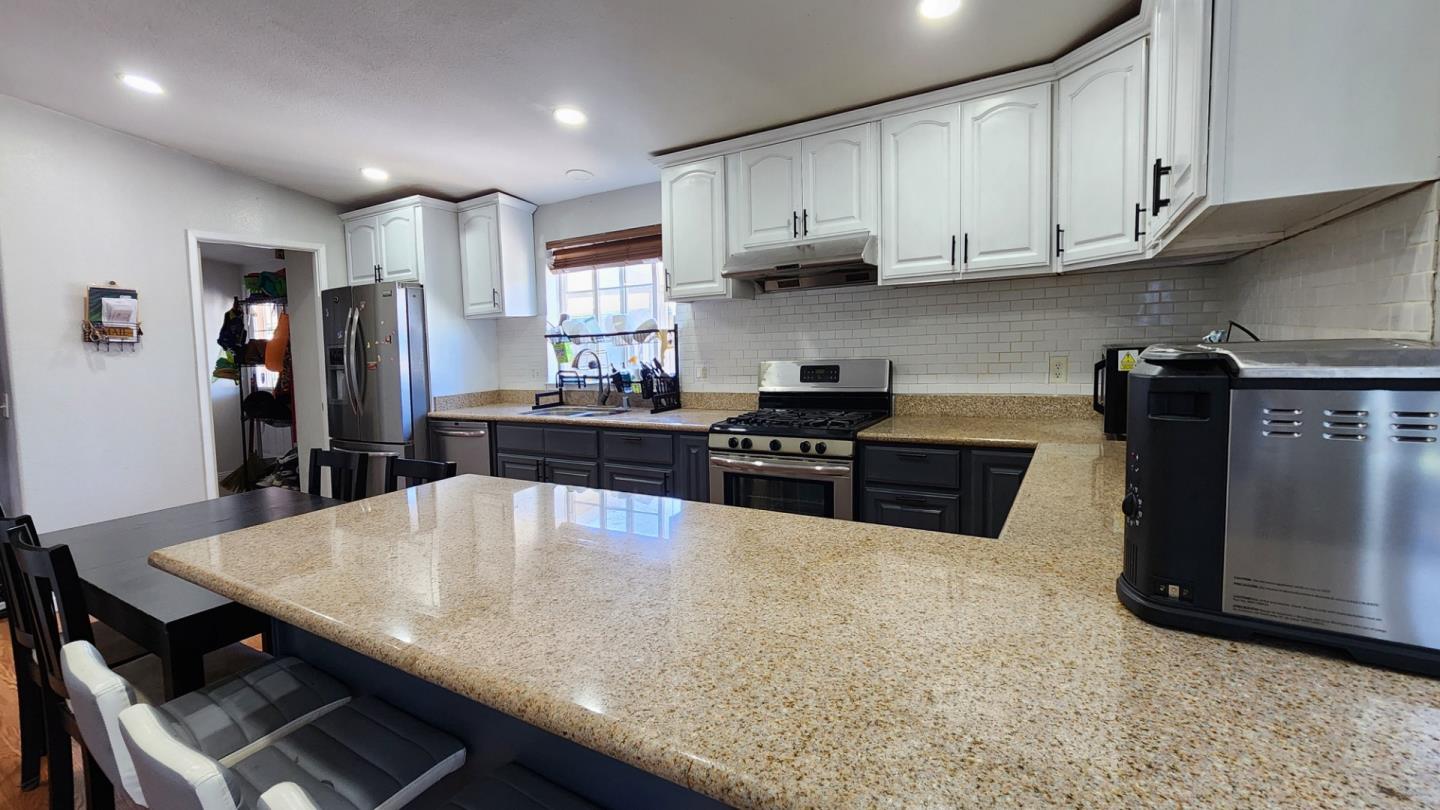 5450 Monterey Road, Unit 142 San Jose, CA 95111 - Photo 7 of 15 a kitchen with stainless steel appliances granite countertop a sink a stove and refrigerator