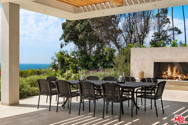 a view of a patio with table and chairs and potted plants