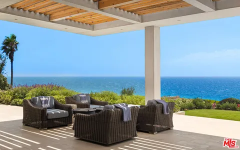 a balcony with furniture and a garden