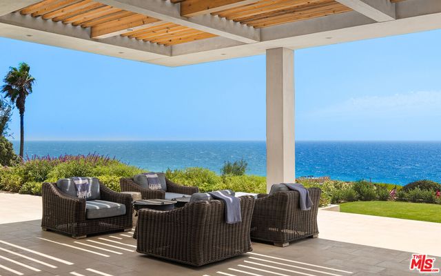 a balcony with furniture and a garden