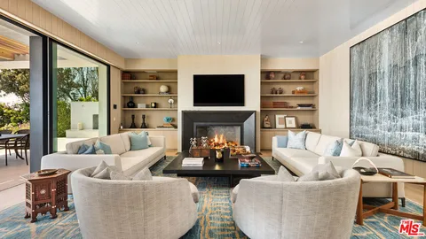 a living room with fireplace furniture and a flat screen tv