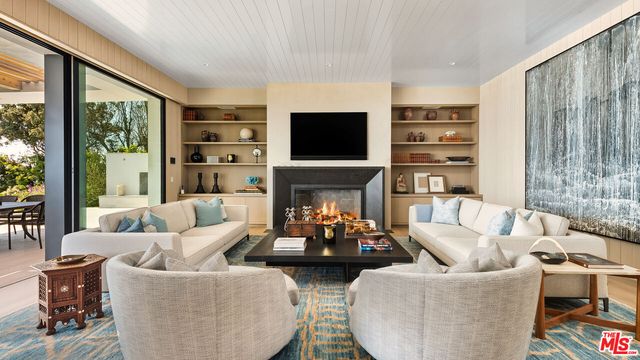 a living room with fireplace furniture and a flat screen tv