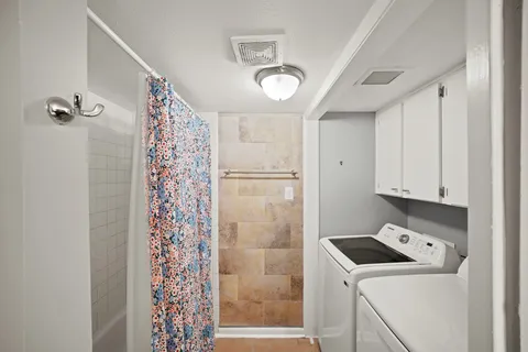 a room with a refrigerator and a window