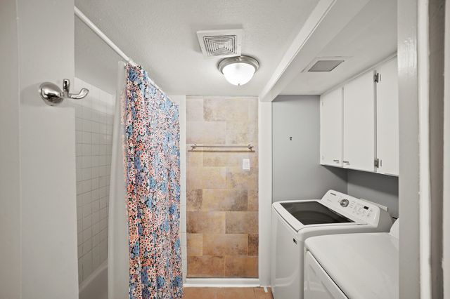 a room with a refrigerator and a window