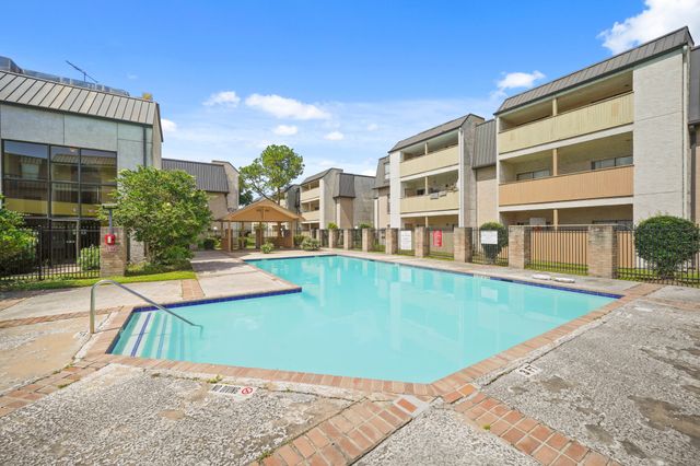 a view of a swimming pool with a lounge chairs