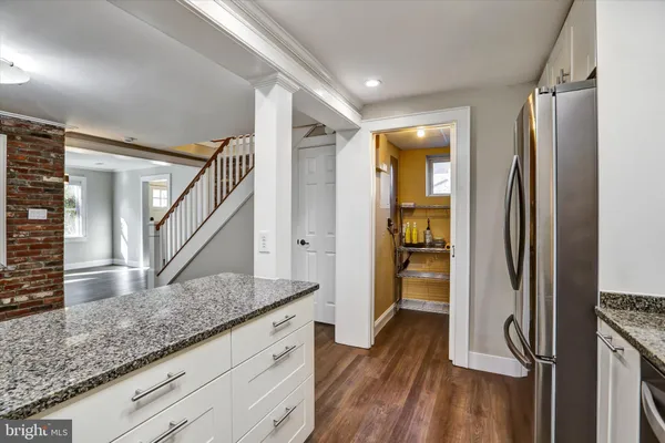 a view of hallway with wooden floor and staircase