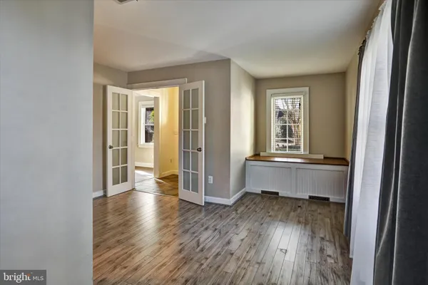 a room with wooden floor and a window