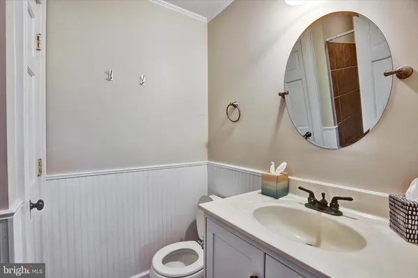 a bathroom with a sink vanity and toilet