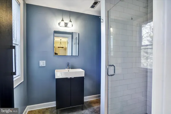 a bathroom with a toilet and a mirror