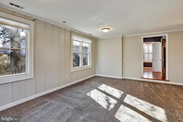 a view of a big room with windows and entryway