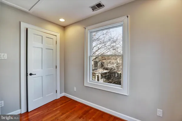 a view of an empty room and wooden floor