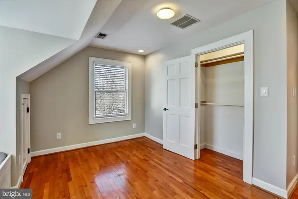 a view of room with wooden floor and closet