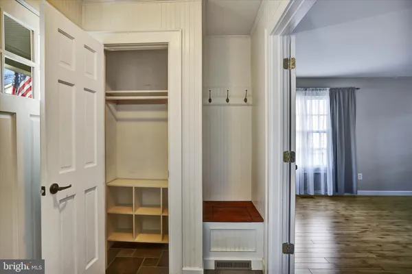 a view of a hallway with closet and wooden floor