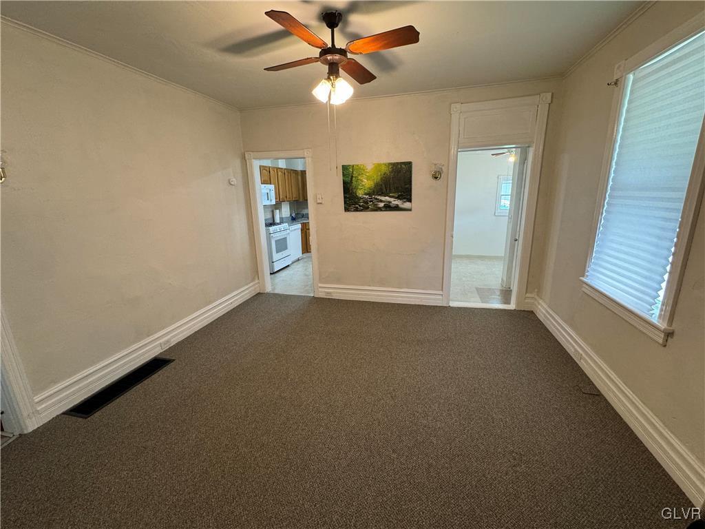 128 Center Street Slatington, PA 18080 - Photo 3 of 9 an empty room with windows and fan