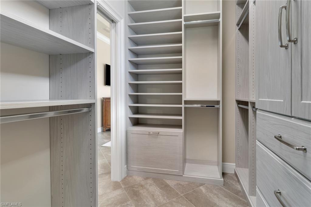 21450 Strada Nuova Circle, Unit A301 Estero, FL 33928 - Photo 13 of 40 a view of walk in closet with empty racks
