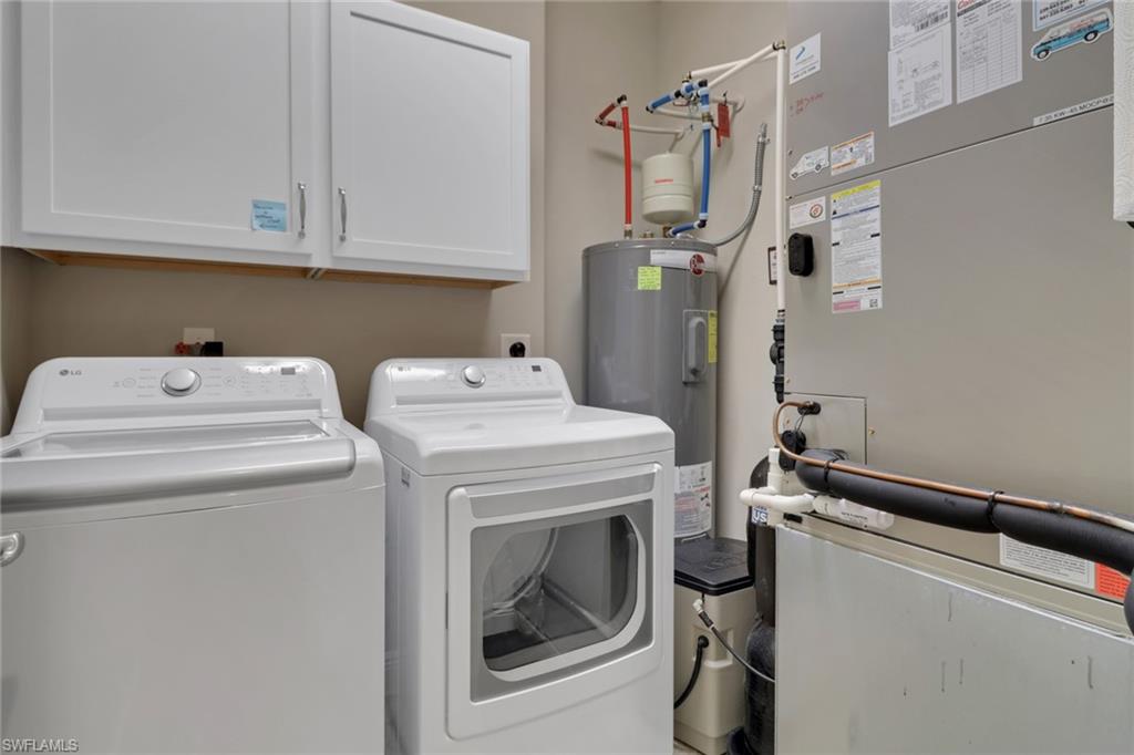 21450 Strada Nuova Circle, Unit A301 Estero, FL 33928 - Photo 25 of 40 a utility room with dryer and washer