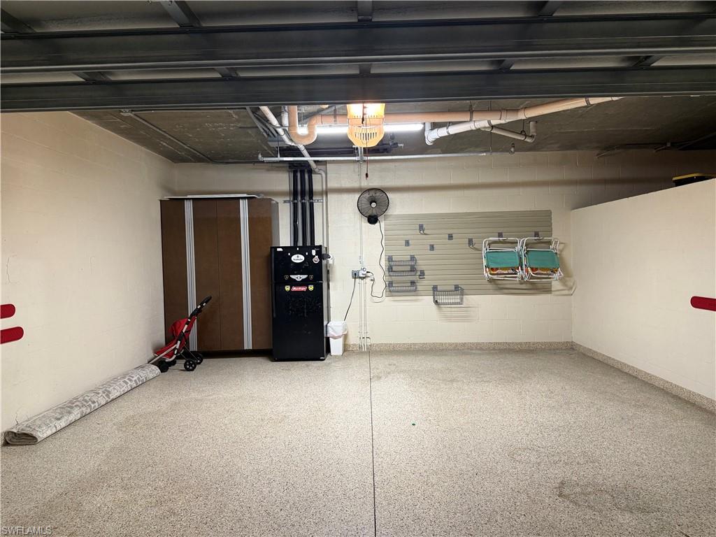 21450 Strada Nuova Circle, Unit A301 Estero, FL 33928 - Photo 28 of 40 a view of water heater room with refrigerator