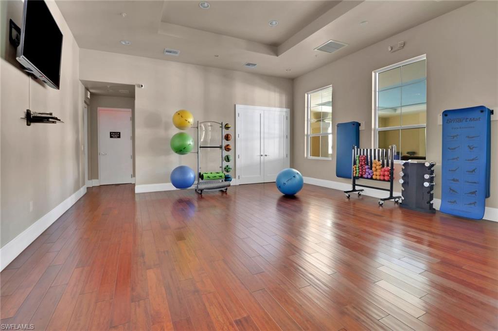 21450 Strada Nuova Circle, Unit A301 Estero, FL 33928 - Photo 39 of 40 a living room with furniture and a wooden floor