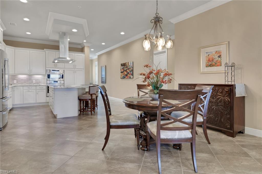 21450 Strada Nuova Circle, Unit A301 Estero, FL 33928 - Photo 5 of 40 a view of a dining room with furniture and chandelier