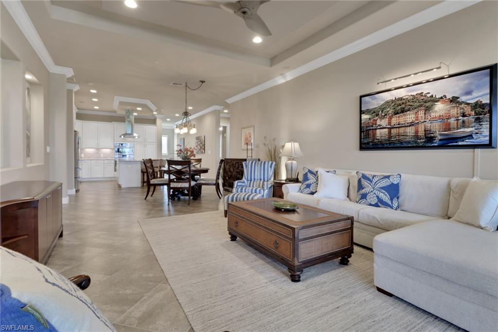 21450 Strada Nuova Circle, Unit A301 Estero, FL 33928 - Photo 6 of 40 a living room with furniture and view of kitchen