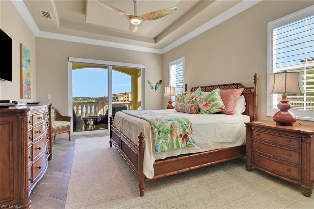 21450 Strada Nuova Circle, Unit A301 Estero, FL 33928 - Photo 8 of 40 a bedroom with a bed and a flat tv screen on dresser