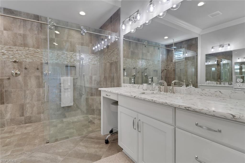 21450 Strada Nuova Circle, Unit A301 Estero, FL 33928 - Photo 10 of 40 a bathroom with a shower sink and mirror