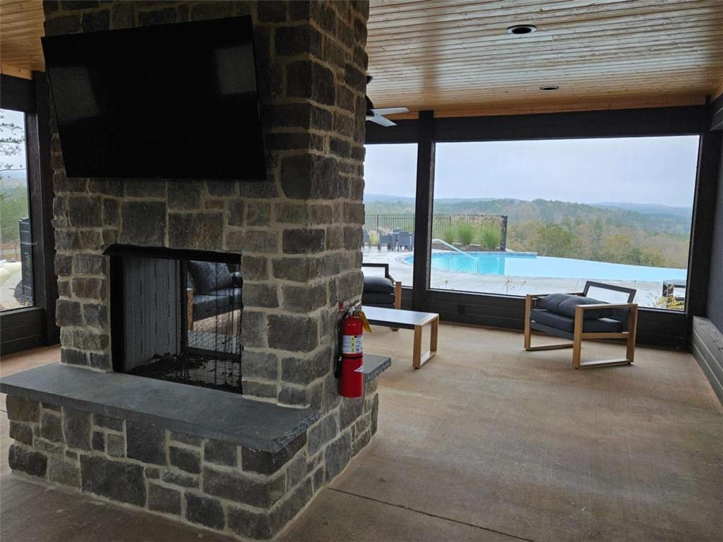 0 Canoe Way Talking Rock, GA 30175 - Photo 11 of 18 a living room with patio furniture and a fireplace
