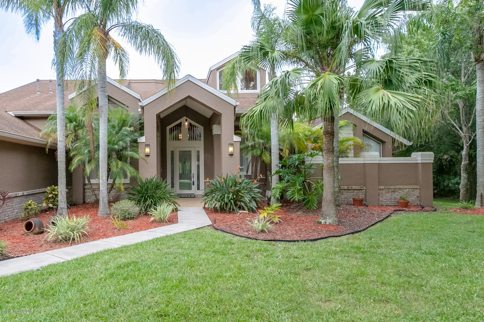 4247 Turtle Mound Road Melbourne, FL 32934 - Photo 3 of 74 a view of a house with a yard and potted plants