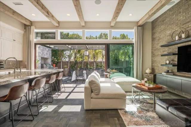a living room with granite countertop furniture a fireplace and a floor to ceiling window