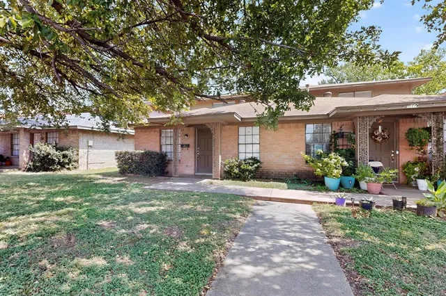 a front view of a house with a yard and a garage