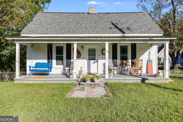a view of a house with sitting area and garden