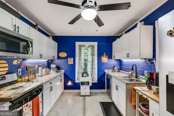 a kitchen with stainless steel appliances granite countertop a stove and a microwave