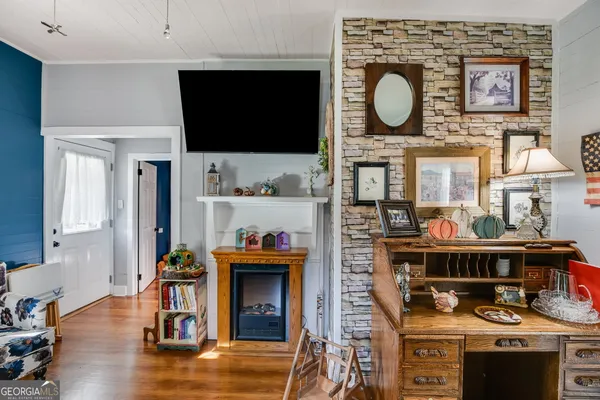 a living room with furniture a flat screen tv and a fireplace