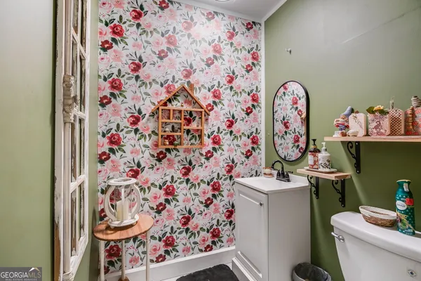a bathroom with a toilet and a shower curtain