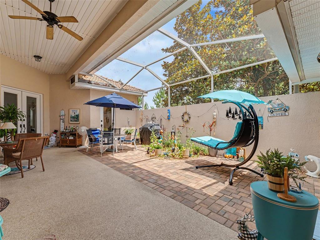 8910 Jericho Road Weeki Wachee, FL 34613 - Photo 12 of 52 a view of a patio with table and chairs potted plants