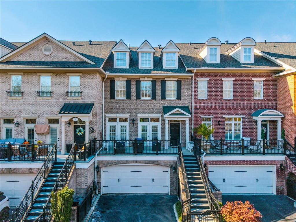 3 Buford Village Way Buford, GA 30518 - Photo 1 of 40 a front view of a building with balcony and outdoor seating