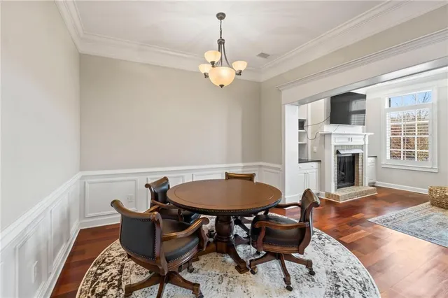 a kitchen with stainless steel appliances granite countertop a stove and a wooden floor