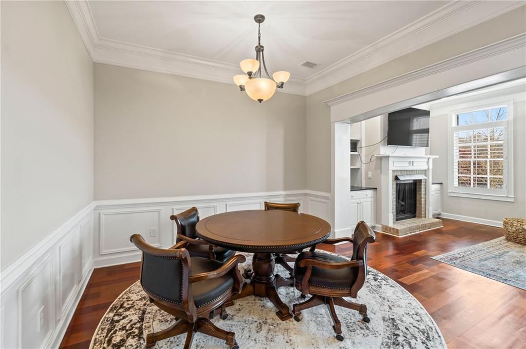 3 Buford Village Way Buford, GA 30518 - Photo 12 of 40 a dining room with furniture a chandelier and wooden floor