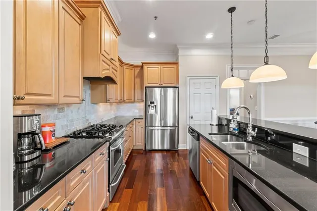 a kitchen with stove and wooden floor