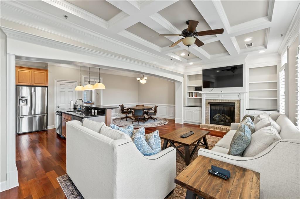 3 Buford Village Way Buford, GA 30518 - Photo 18 of 40 a living room with furniture a flat screen tv and a fireplace