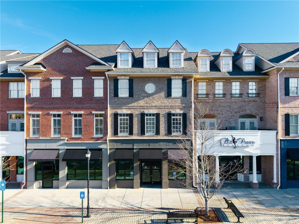 3 Buford Village Way Buford, GA 30518 - Photo 2 of 40 a front view of a building with many windows