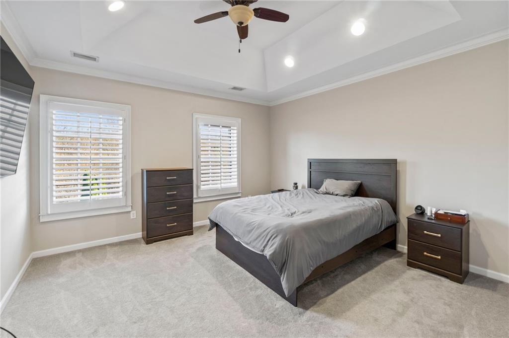 3 Buford Village Way Buford, GA 30518 - Photo 24 of 40 a bedroom with a bed and a chandelier