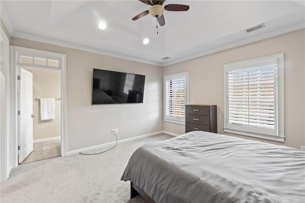 3 Buford Village Way Buford, GA 30518 - Photo 25 of 40 a bedroom with a bed and a flat screen tv