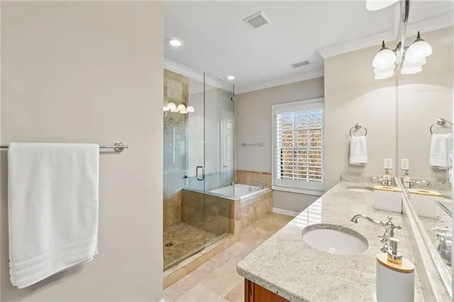 a bathroom with a granite countertop double vanity sink and a mirror