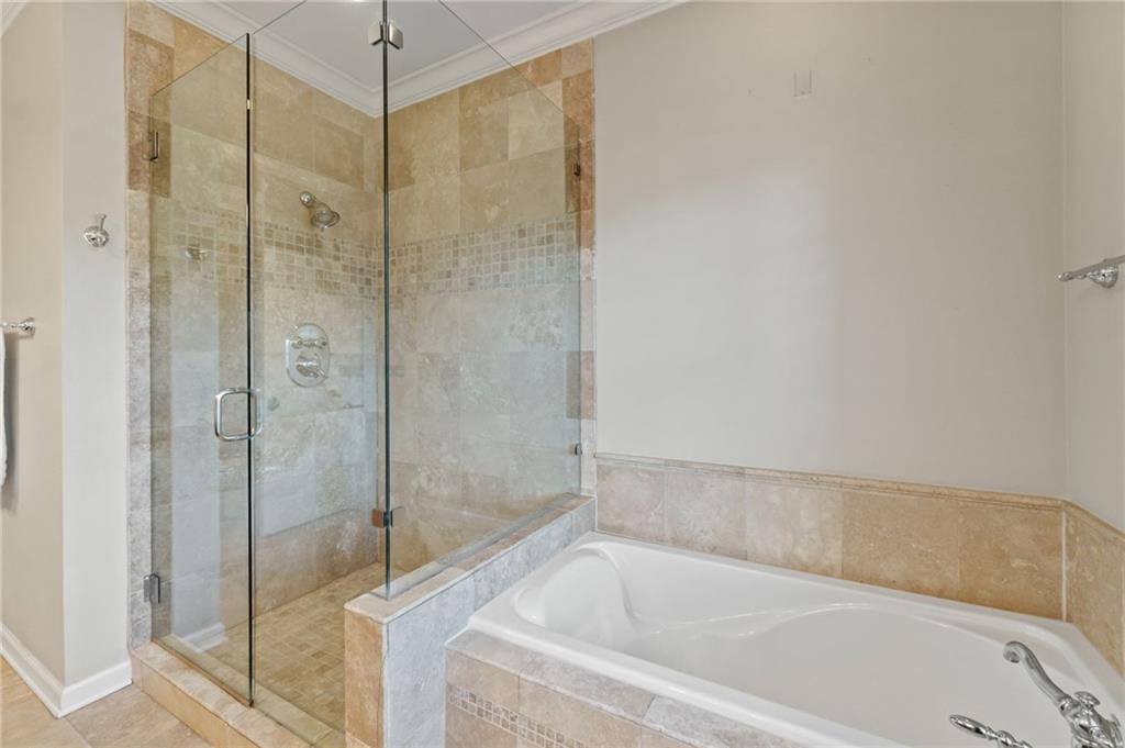 3 Buford Village Way Buford, GA 30518 - Photo 27 of 40 a white bath tub sitting next to a shower