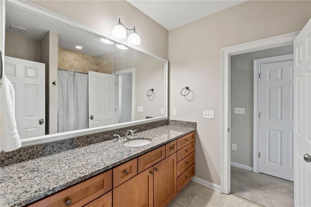 3 Buford Village Way Buford, GA 30518 - Photo 30 of 40 a bathroom with a granite countertop sink and a mirror