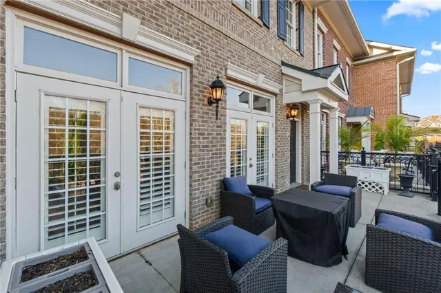 a view of a patio with couches chairs and wooden floor