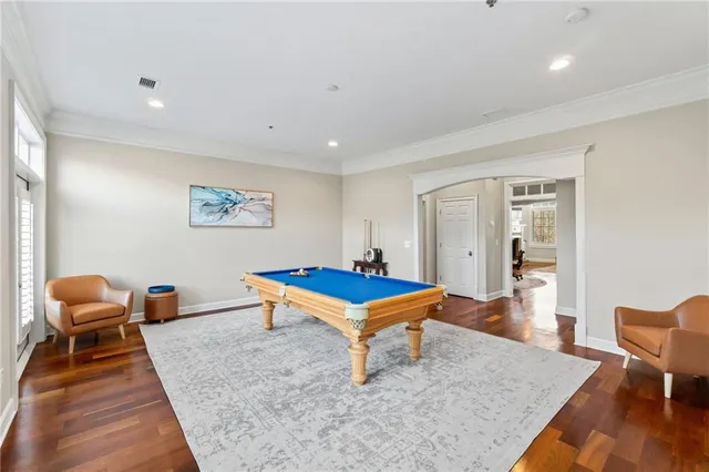a room with pool table and windows