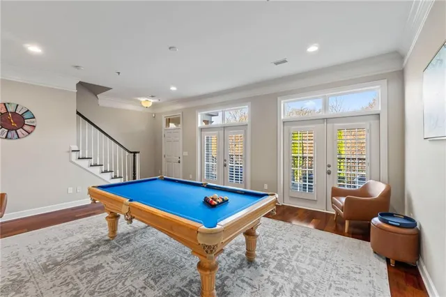 a room with pool table and a rug